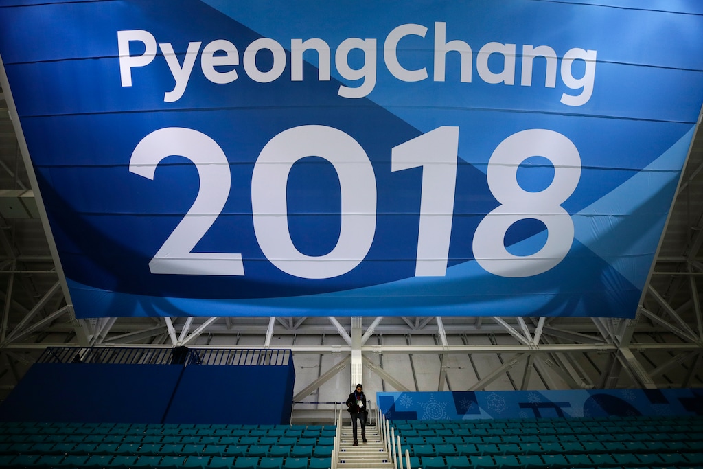 FILE - In this Feb. 6, 2018, file photo, a photographer walks down the steps underneath a large banner at the Gangneung Hockey Center ahead of the 2018 Winter Olympics in Gangneung, South Korea. Fresh off the Super Bowl, NBC begins more than two weeks of Winter Olympics coverage on Thursday, Feb. 8,  with a new host, some new wrinkles and the hope that its business model keeps pace with the different ways people experience events on television and online. (AP Photo/Jae C. Hong, File)
