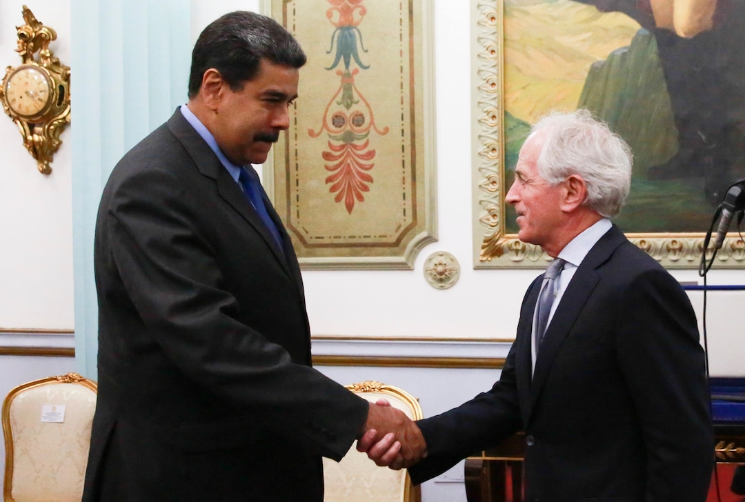 (Miraflores Presidential Press Office via AP)  In this photo released by the Miraflores Presidential Press Office, Venezuela's President Nicolas Maduro, left, shakes hands with Republican Senator Bob Corker during a meeting at the Miraflores Presidential Palace in Caracas, Venezuela, Friday May 25, 2018. The Chairman of Senate Foreign Relations Committee met with Venezuelan President Nicolas Maduro two days after the embattled socialist leader kicked out the top U.S. diplomat in the country. There was no immediate comment from Republican Senator Bob Corker's office about the nature of the surprise visit.
