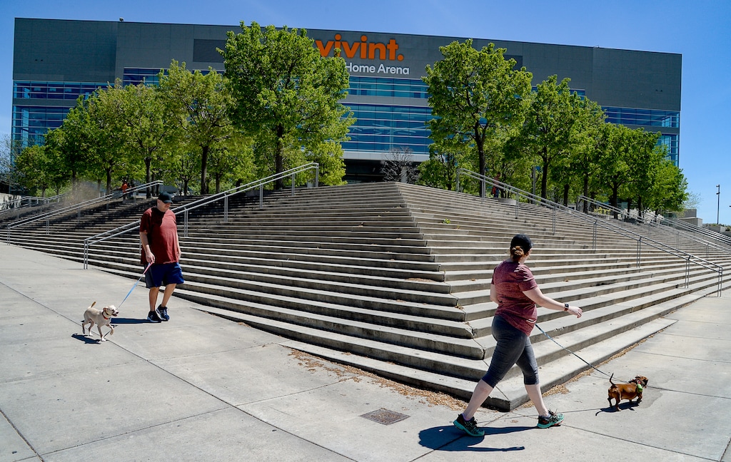 (Francisco Kjolseth | The Salt Lake Tribune) People walk past the Vivint Smart Home Arena in Salt Lake City which remains closed due to the COVID-19 pandemic on Wednesday, April 29, 2020.