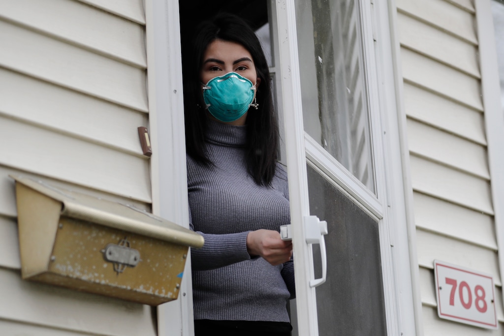 (Nam Y. Huh | The Associated Press) Francy Sandoval poses for a portrait at her home in Melrose Park, Ill., Thursday, April 23, 2020. She works as a receptionist at a community health clinic which treats multiple COVID-19 cases. She has to isolate herself in the attic as soon as she comes home from work each day and is terrified of infecting her family.