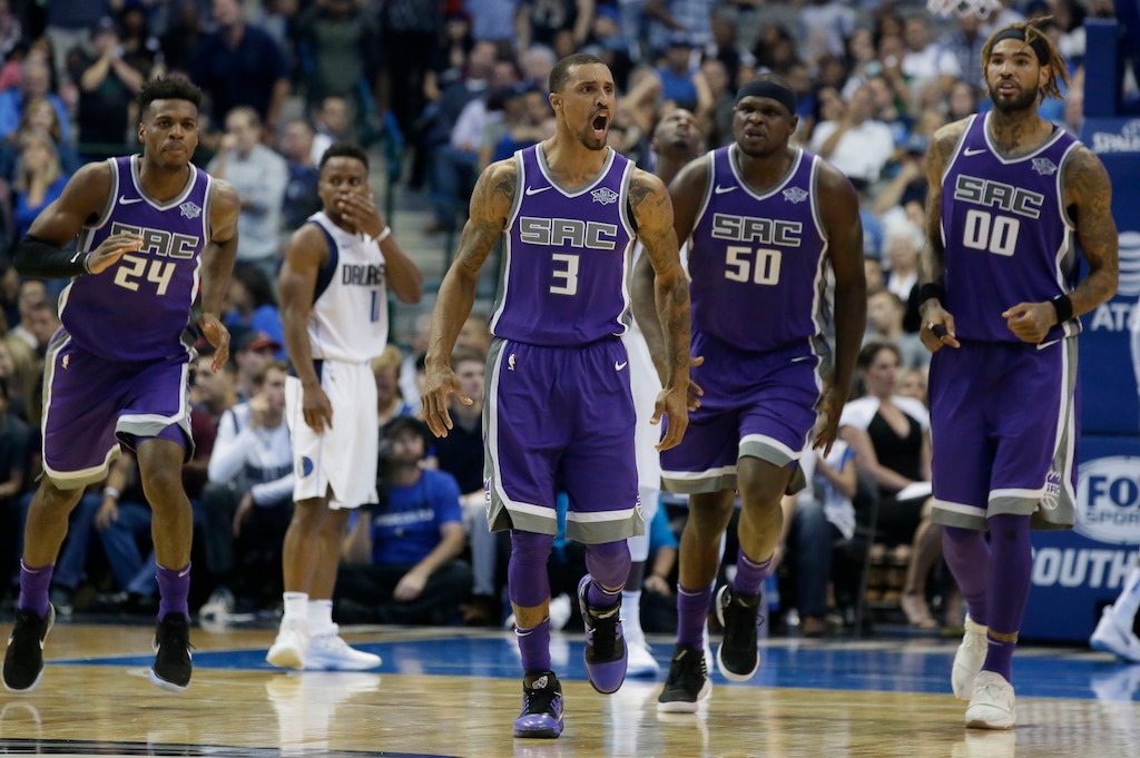 Sacramento Kings guard George Hill (3) reacts to scoring basket as teammates Buddy Hield (24), Zach Randolph (50) and Willie Cauley-Stein (00) follow during the second half of an NBA basketball game against the Dallas Mavericks in Dallas, Friday, Oct. 20, 2017. The Kings won 93-88. (AP Photo/LM Otero)