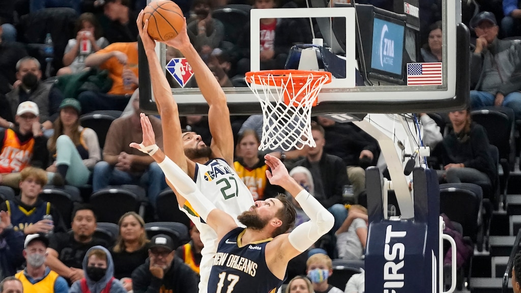Utah Jazz center Rudy Gobert (27) dunks against New Orleans Pelicans' Jonas Valanciunas in the first half of a preseason NBA basketball game Monday, Oct. 11, 2021, in Salt Lake City. (AP Photo/Rick Bowmer)