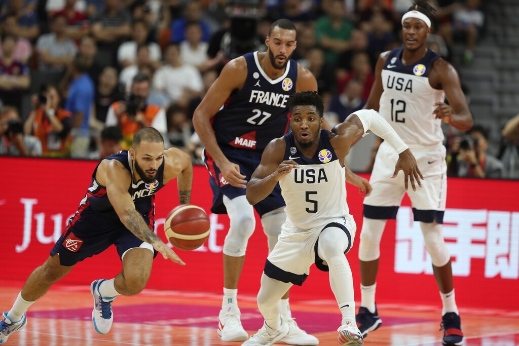 (Ng Han Guan | AP Photo) United States' Donovan Mitchell, center and France's Evan Fournier at left races for the ball during a quarterfinal match for the FIBA Basketball World Cup in Dongguan in southern China's Guangdong province on Wednesday, Sept. 11, 2019. France defeated United States 89-79.