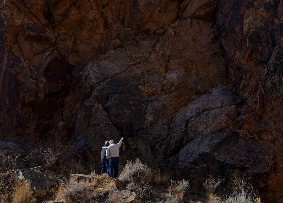 (Leah Hogsten | The Salt Lake Tribune)  Morris Smith, left, of Lancaster, CA and Chris Chipping, right, of Levan discuss petroglyphs at Parowan Gap, March 20, 2021. Smith and Chipping, best friends since age 13 when they were neighbors in Salt Lake City, take trips to visit each other and their wives every chance they get.