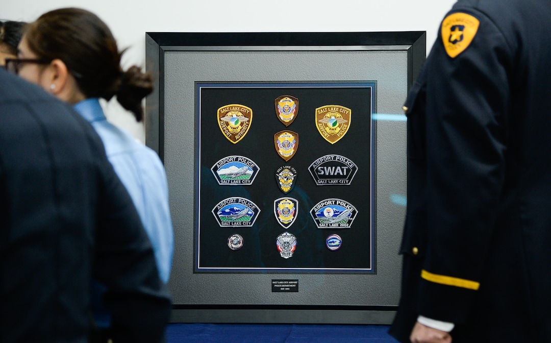 (Francisco Kjolseth  |  The Salt Lake Tribune)  A shadowbox of memorabilia holds former patches and badges used by the airport police over the years, displayed during a ceremony to retire officers current patch and badge as they are subsumed into the Salt Lake City Police Department on Tuesday, Feb. 26, 2019.