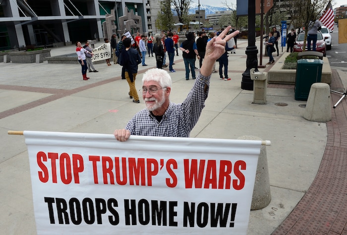 (Scott Sommerdorf | The Salt Lake Tribune)
Bob Brister encouraged support from passing drivers as a group of about 40 people protested the strikes on Syria, Sunday, April 15, 2018.