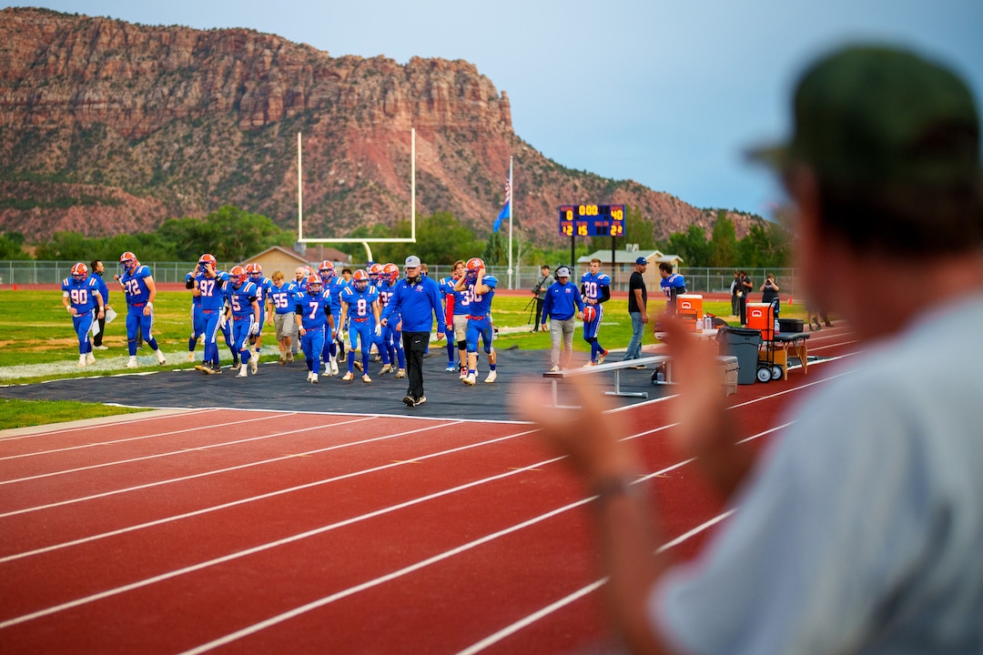 (Trent Nelson  |  The Salt Lake Tribune) Down 0-40 at halftime of their first-ever football game, Water Canyon High School football players are applauded by fans in Hildale on Friday, Aug. 12, 2022.