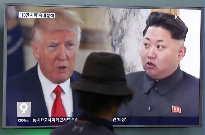 FILE- In this Aug. 10, 2017, file photo, a man watches a television screen showing U.S. President Donald Trump, left, and North Korean leader Kim Jong Un during a news program at the Seoul Railway Station in Seoul, South Korea. America’s annual joint military exercises with South Korea always frustrate North Korea. The war games set to begin Monday, Aug. 21, 2017 may hold more potential to provoke than ever, given Trump’s “fire and fury” threats and Pyongyang’s as-yet-unpursued plan to launch missiles close to Guam. (AP Photo/Ahn Young-joon, File)