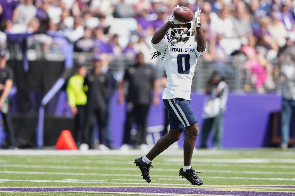 Utah State wide receiver Javon Robinson, shown during a game against Washington, scored on the Aggies' first offensive play in a win over Troy on Saturday night. (AP Photo/Lindsey Wasson)