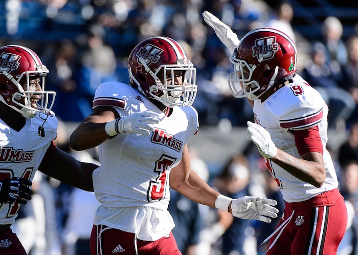 (Trent Nelson | The Salt Lake Tribune)  Massachusetts Minutemen cornerback Lee Moses (3) and Massachusetts Minutemen cornerback Isaiah Rodgers (9) celebrate an interception by Moses as BYU hosts the University of Massachusetts, NCAA football in Provo, Saturday November 18, 2017.