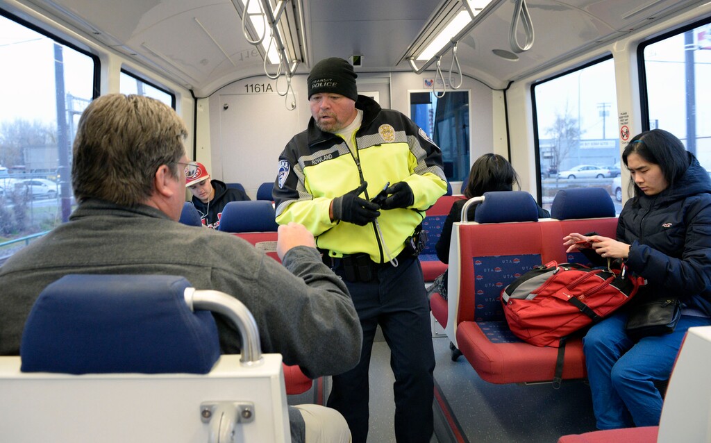 Al Hartmann  |  The Salt Lake TribuneUTA police officer Steve Rowland checks passengers on a TRAX train for  tickets.  You never know where or when along bus or TRAX lines where they will appear to check for your  ticket. 
