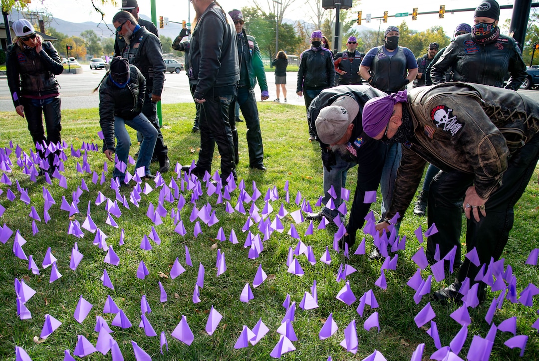 (Francisco Kjolseth  |  The Salt Lake Tribune) Members of Bikers Against Domestic Violence, plant a purple flag at Liberty Park in Salt Lake City on Saturday, Oct. 17, 2020, representing an individual who received services from the YWCA Utah last year as part of the Stop the Violence Utah campaign.