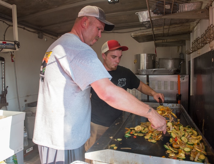 (Rachel Molenda  |  The Salt Lake Tribune)  Chester Russell, left, and Wyatt Brown, right, grill vegetables for dinner at the Sunset Grill mobile kitchen in Kountze, Utah, on Tuesday, Sept. 5, 2017.