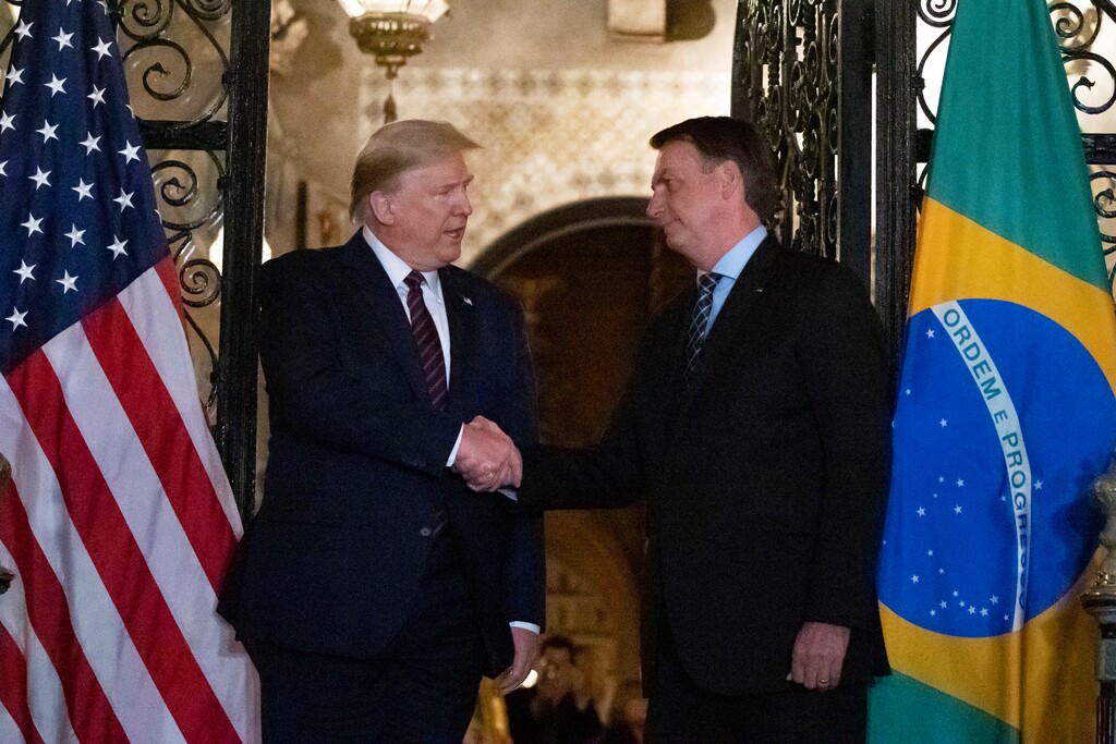 (Alex Brandon | The Associated Press)
President Donald Trump shakes hands before a dinner with Brazilian President Jair Bolsonaro at Mar-a-Lago, Saturday, March 7, 2020, in Palm Beach, Fla.