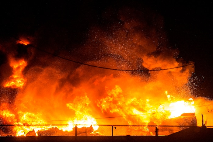 (Chris Detrick  |  The Salt Lake Tribune)  Firefighters attempt to put out a burning semitrailer that was hauling thousands of gallons of fuel on Interstate-15 in Midvale Thursday, January 18, 2018.   Lt. Todd Royce of the Utah Highway Patrol said the truck was southbound on the interstate at 7500 South at 7:20 p.m. when a tire caught fire, sending flames toward the tanks.