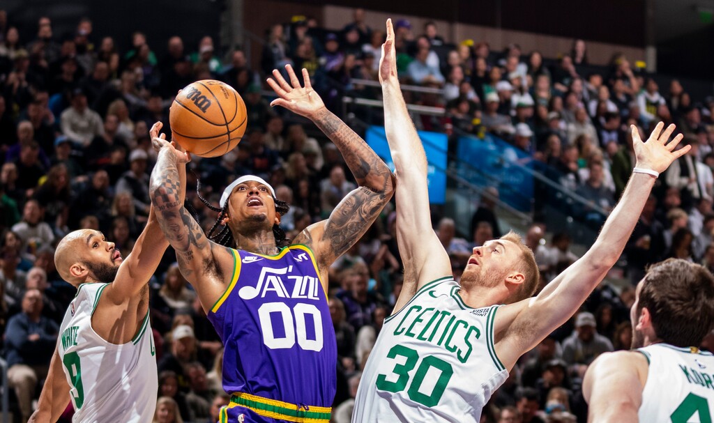 (Rick Egan | The Salt Lake Tribune) Utah Jazz guard Jordan Clarkson (00) shoots as Boston Celtics guard Derrick White (9) and Boston Celtics forward Sam Hauser (30) defend, in NBA action between the Utah Jazz and the Boston Celtics, at the Delta Center, on Tuesday, March 12, 2024.