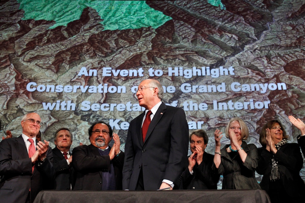 (Jacquelyn Martin  |  AP Photo) In this Jan. 9, 2012 file photo, then Interior Secretary Ken Salazar, center, standing in front of a map of the Grand Canyon, is applauded after announcing a twenty year ban on new mining claims near the Grand Canyon in Washington.  A federal appeals court has revived a challenge to a company's right to mine uranium near the Grand Canyon. The 9th U.S. Circuit Court of Appeals on Thursday, Oct. 25, 2018, said a lower court must determine whether the U.S. Forest Service erred in finding that Energy Fuels had a valid, existing right to mine outside the national park's South Rim entrance. Environmentalists and the Havasupai Tribe had challenged the Forest Service's decision.