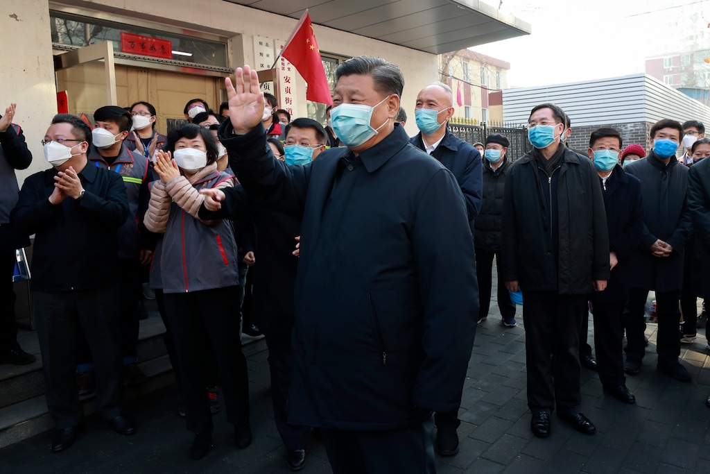 (Pang Xinglei | Xinhua via AP) In this photo released by Xinhua News Agency, Chinese President Xi Jinping, center, wearing a protective face mask, waves as he inspects the novel coronavirus pneumonia prevention and control work at a neighborhood in Beijing, Monday, Feb. 10, 2020. China reported a rise in new virus cases on Monday, possibly denting optimism that its disease control measures like isolating major cities might be working, while Japan reported dozens of new cases aboard a quarantined cruise ship.