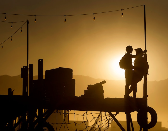 (Rick Egan  |  The Salt Lake Tribune)A couple hangs out on the Pier by Mathew Shultz, at sunset, during Burning Man, in the Black Rock Desert, north of Reno Nevada, Saturday, September 2, 2017.