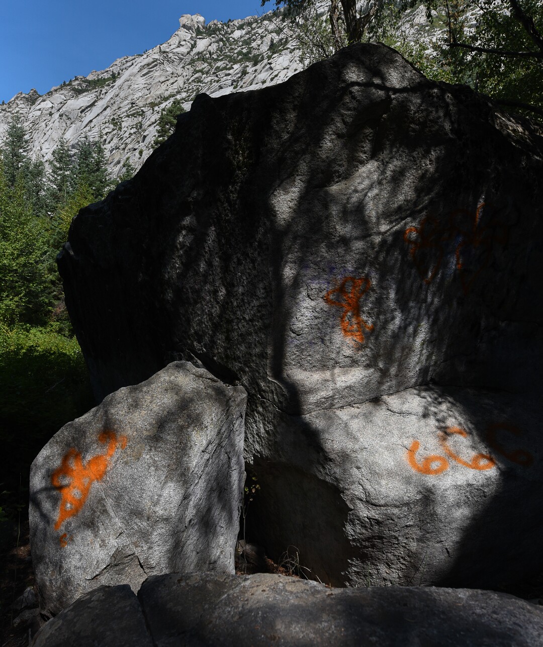 (Francisco Kjolseth  |  The Salt Lake Tribune)  Graffiti has proliferated in lower Little Cottonwood Canyon, where vandals, often wielding cans of fluorescent-colored spray paint, have covered granite faces, trees and structures. The vandalism is particularly apparent along the Temple Quarry Trail and the creek at the Moon Rock swimming hole and former pavilion site. Volunteers using donated equipment and solvents spend thousands of hours removing the paint from the rocks only to see graffiti return to the same faces or on rock nearby.