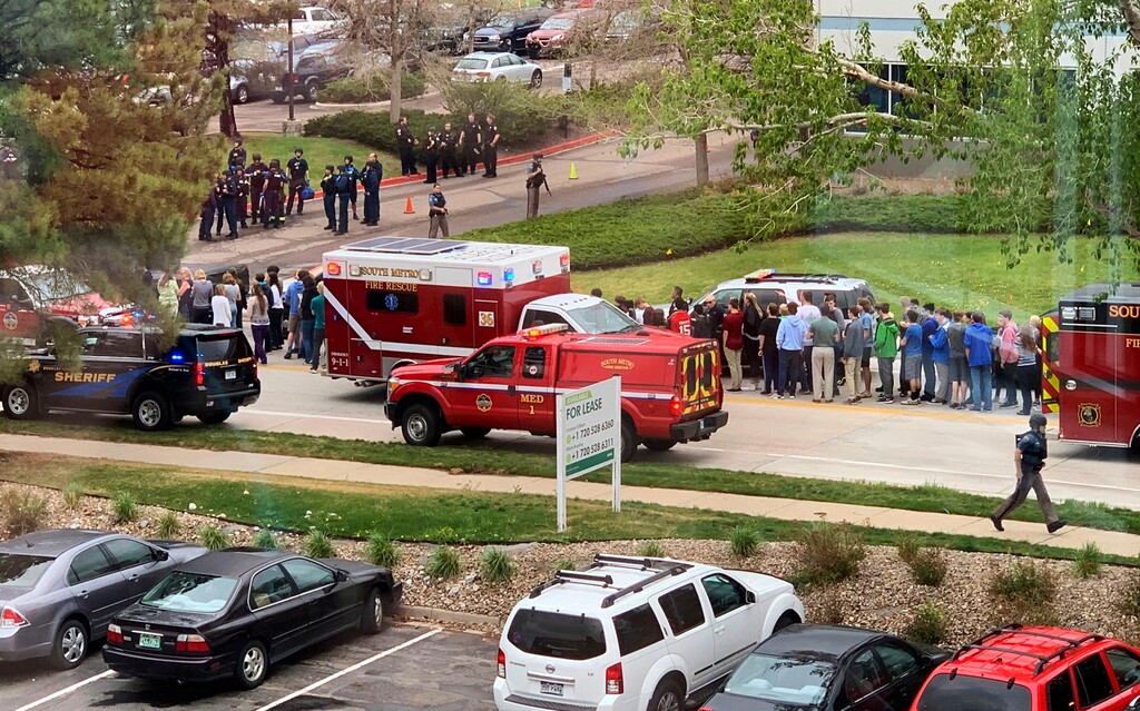 (Courtney Harper | AP, File) In this Tuesday, May 7, 2019, photo, police officers and students are outside STEM School Highlands Ranch, a charter middle school in the Denver suburb of Highlands Ranch, Colo., after a shooting. Both suspects in the suburban Denver school shooting are due back in court Friday, May 10, as prosecutors file charges in the violent attack that killed a student and wounded multiple others. Authorities have identified the suspects as 18-year-old Devon Erickson and 16-year-old Maya McKinney, whose attorney said uses male pronouns and the name Alec.