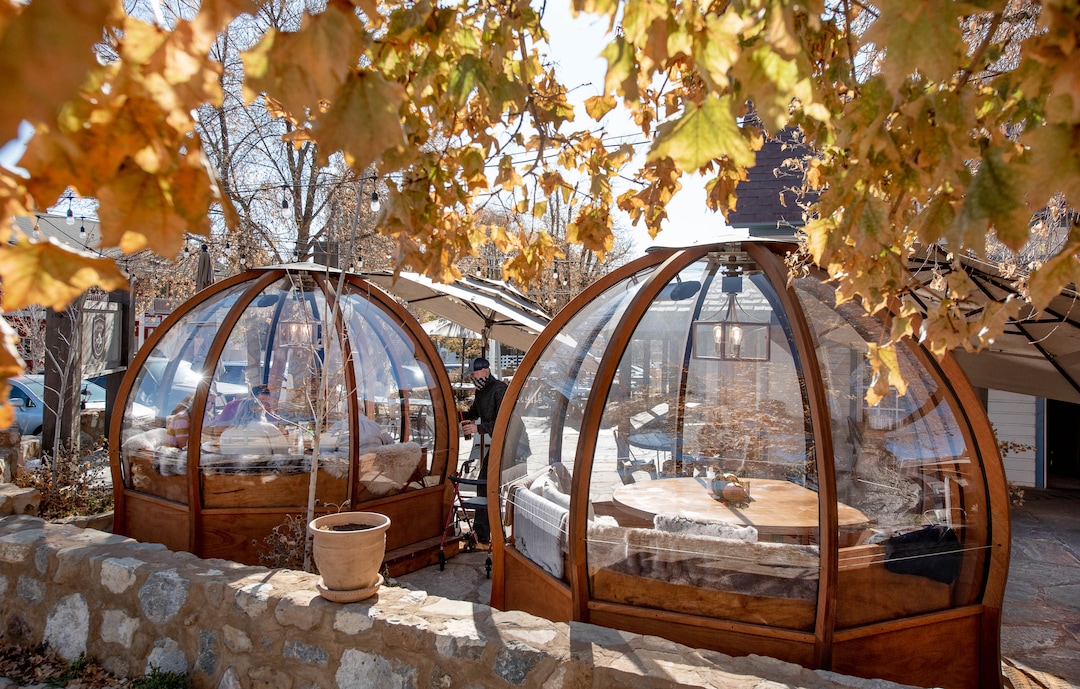 (Francisco Kjolseth  |  The Salt Lake Tribune) The dome-like Alpenglobes that allow diners to eat inside a warm environment, while also being separated from others have been added at Cafe Galleria in Midway as people enjoy brunch on Thursday, Nov. 5, 2020. The owners were trying to find a way to use their outdoor patio in the winter, teaming up with Insight Exhibit, a Salt Lake City corporate event company that was looking for a way to make money while large gatherings have been cancelled.