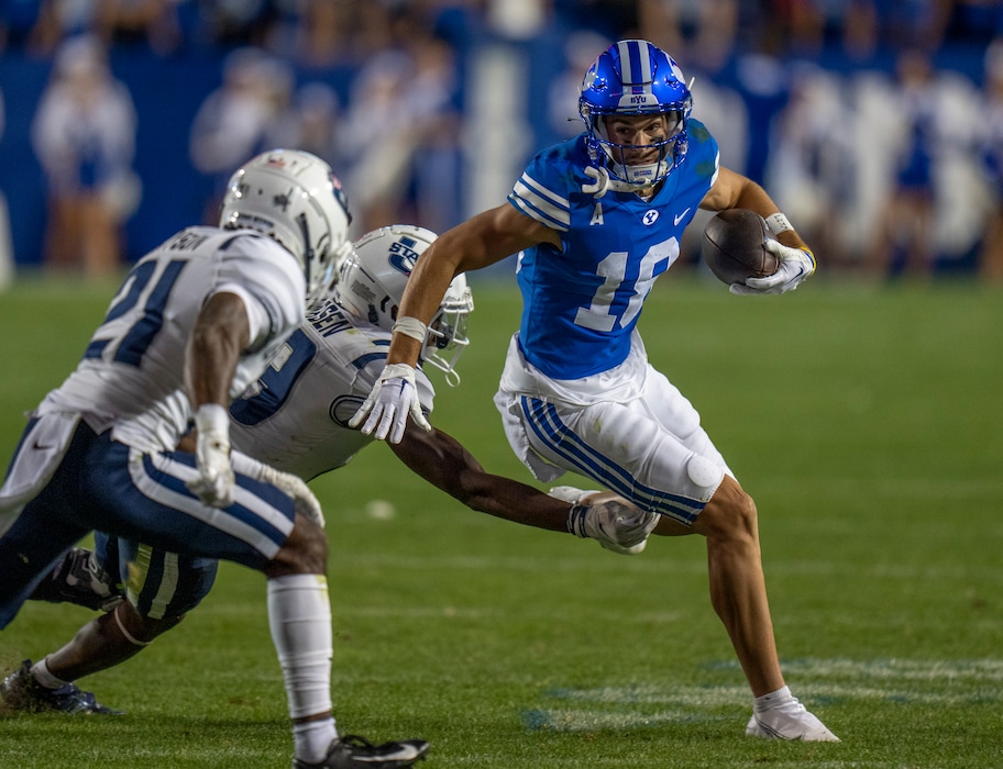(Rick Egan | The Salt Lake Tribune) Brigham Young Cougars wide receiver Gunner Romney (18) for extra yards after catching a pass, in Football action between the Brigham Young Cougars and the Utah State Aggies, at LaVell Edwards Stadium in Provo, on Thursday, Sept. 29, 2022.