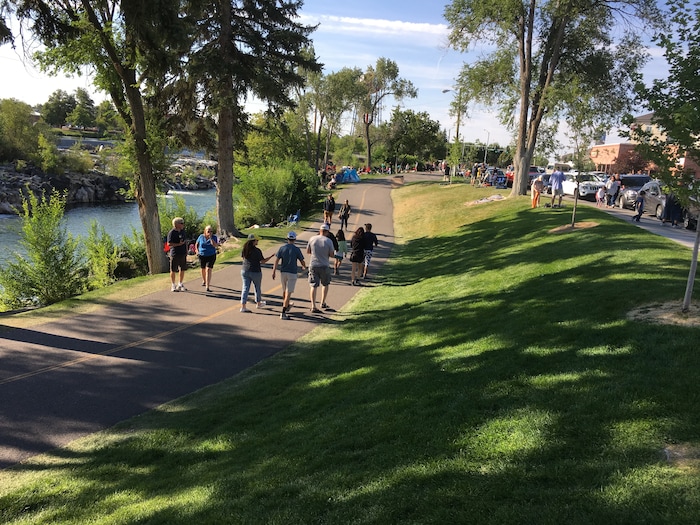 (Tom Wharton | The Salt Lake Tribune) Eclipse chasers walk along the Snake River in Idaho falls, Idaho. The town falls in the path of totality for the Aug. 21, 2107, eclipse.