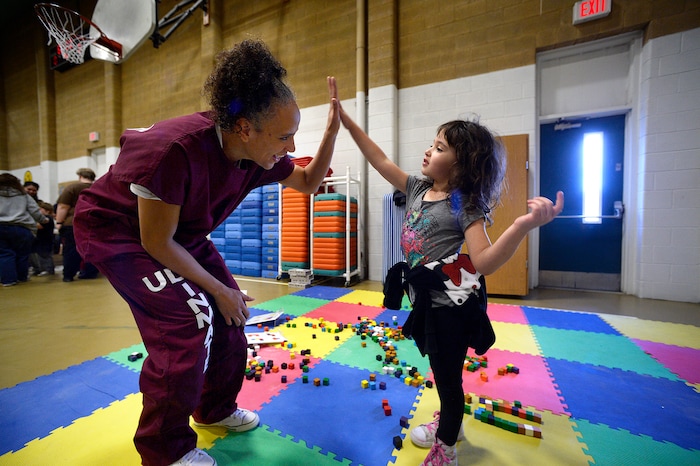 (Scott Sommerdorf   |  The Salt Lake Tribune)   Inmate Angela Rekoutis plays with her daughter Ava during "Kids Day" at the Utah State Prison, Saturday, October 7, 2017. The day allows incarcerated mothers an extended visit with their children for events and activities not allowed during regular visits - including meals, games and craft projects.