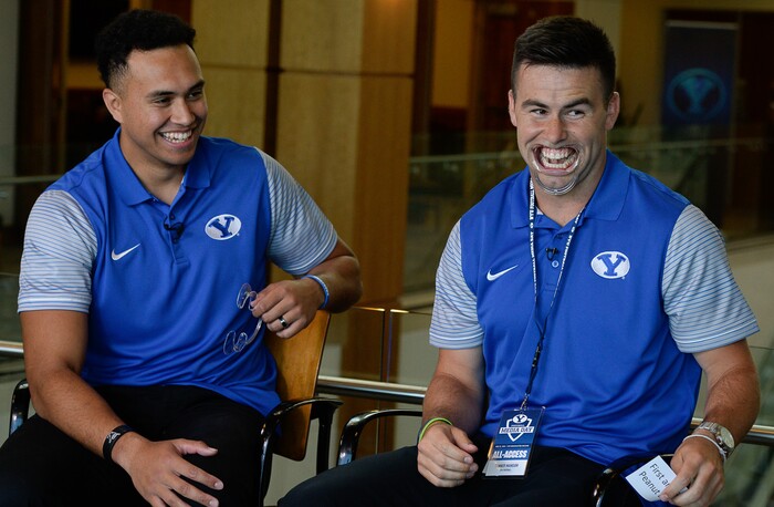 (Francisco Kjolseth  |  The Salt Lake Tribune)  Tight end Moroni Laulu-Pututau and quarterback Tanner Mangum are put through a round of the game "Speak Out" during an interview as part of the eighth-annual football media day at the BYU-Broadcasting Building on Friday, June 22, 2018.