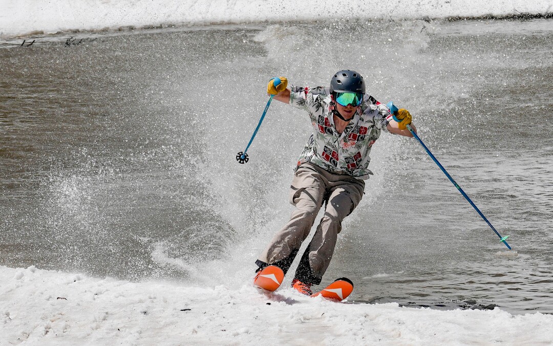 (Francisco Kjolseth  | The Salt Lake Tribune) A skier skims the pond in Peruvian Gulch as Snowbird closes the book on the 2024-25 ski season on Monday, May 26, 2025. Snow and sun revelers took to the slushy slopes on Memorial Day as the resort was the last in the state to close.