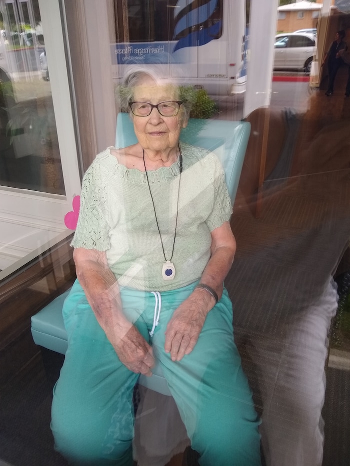 (Photo courtesy of Harold Carr.) Audrey B. Carr sits at a window at Heritage Place Senior Living in Bountiful to visit with her son during the coronavirus pandemic.
