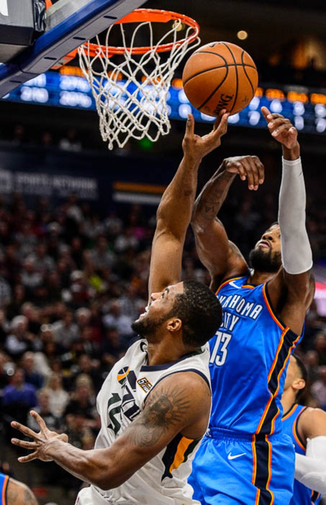 (Trent Nelson | The Salt Lake Tribune)  Oklahoma City Thunder forward Paul George (13) blocks a shot by Utah Jazz forward Derrick Favors (15) as the Utah Jazz host the Oklahoma City Thunder, NBA basketball in Salt Lake City, Saturday December 23, 2017.
