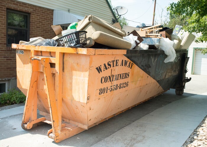 (Rick Egan  |  The Salt Lake Tribune)  A container full of carpet, furniture and other belongings from the residents on 2100 south, that must be destroyed because it was saturated with sewage water in the flood. Tuesday, August 1, 2017.
