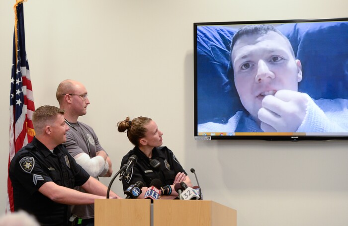 (Francisco Kjolseth  |  The Salt Lake Tribune)  Sgt. Shawn McKinnon, left, is joined by officers Cade Bradshaw, Lacy Turner and Robert Jackson, appearing by video as he recovers at University Hospital burn unit, as they describe the events and injuries they sustained on a call earlier this month involving a man who entered a Chevron gas station store and doused himself with gasoline. As the officers tried to get a lighter from the manÕs hand, the man lit himself on fire injuring all four officers.