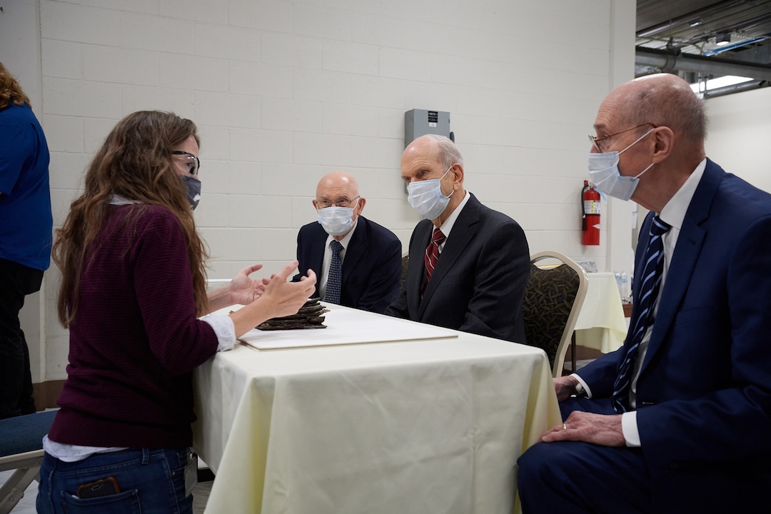 (Photo courtesy of The Church of Jesus Christ of Latter-day Saints) Emiline Twitchell, a conservator at the Church History Library, shows contents from the capstone of the Salt Lake Temple to the First Presidency on May 20, 2020.