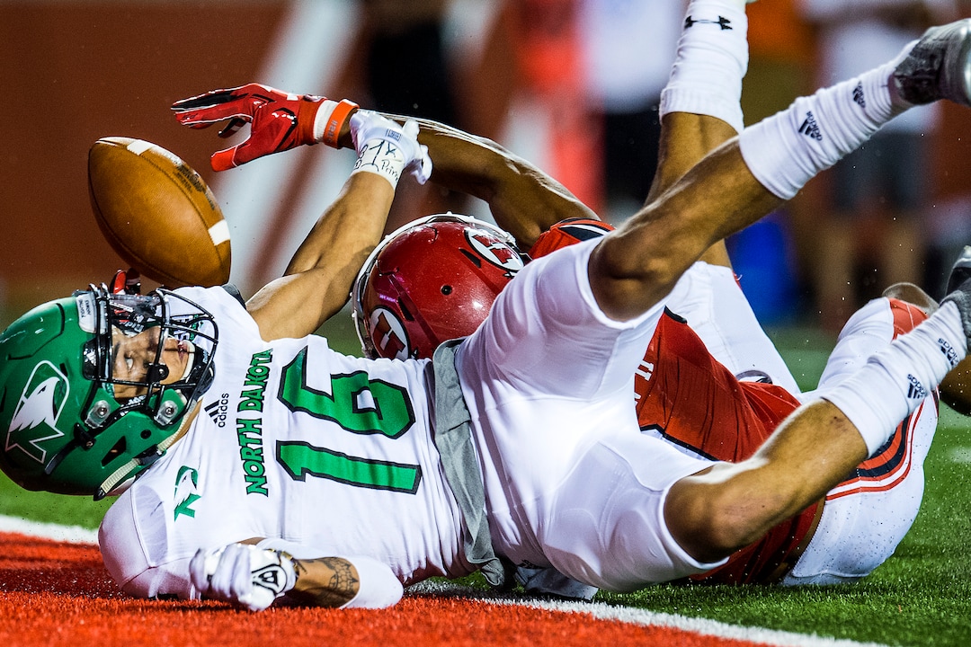 (Chris Detrick  |  The Salt Lake Tribune)  Utah Utes wide receiver Darren Carrington (9) comes up short of a touchdown while being guarded by North Dakota Fighting Hawks defensive back Torrey Hunt (16) during the game at Rice-Eccles Stadium Thursday, August 31, 2017. Utah Utes defeated North Dakota Fighting Hawks 37-16.