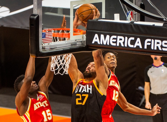 (Rick Egan | The Salt Lake Tribune) Utah Jazz center Rudy Gobert (27) dunks the ball over Atlanta Hawks center Clint Capela (15), in NBA action between the Utah Jazz and the Atlanta Hawks at Vivint Arena, on Friday, Jan. 15, 2021.,