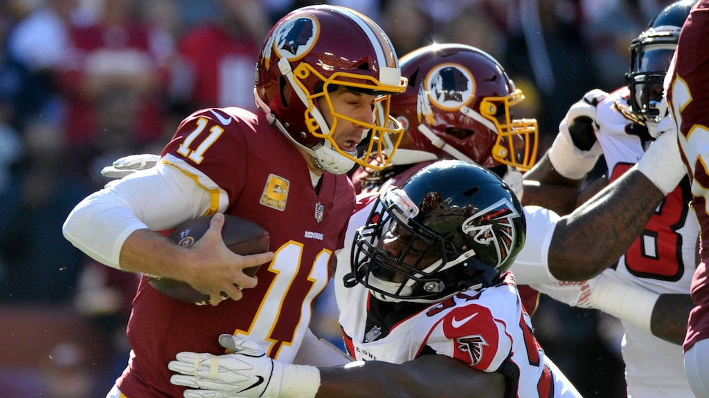FILE - In this Nov. 4, 2018, file photo, Washington Redskins quarterback Alex Smith, left, is sacked by Atlanta Falcons defensive tackle Grady Jarrett during an NFL football game in Landover, Md. The Falcons have agreed to terms with Jarrett on a four-year contract extension before the NFL deadline for franchise-tagged players. (AP Photo/Mark Tenally, File)