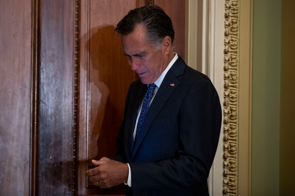 (Anna Moneymaker | The New York Times) Sen. Mitt Romney (R-Utah) checks his phone before attending a Senate policy luncheon on Capitol Hill in Washington on July 23, 2019.