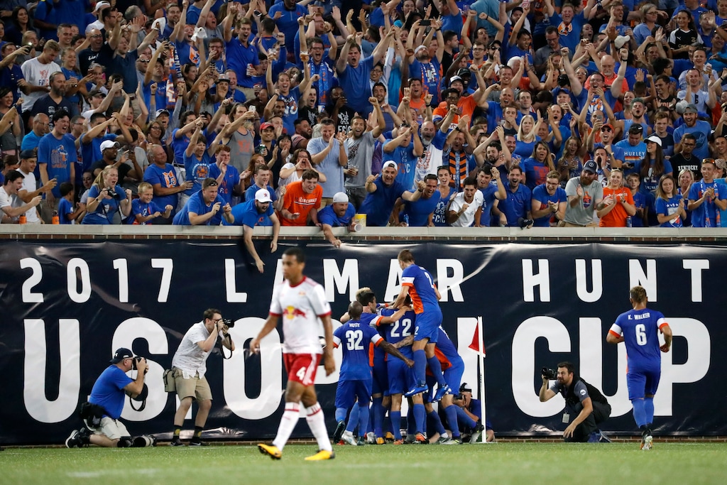 FILE - In this Aug. 15, 2017 file photo, FC Cincinnati players celebrate after midfielder Corben Bone scores in the first half of a U.S. Open Cup soccer semi-final match against the New York Red Bulls in Cincinnati. While Ohio's capital city is trying to figure out to keep its Major League Soccer franchise, folks in Cincinnati are working on getting one. So in a couple years, Ohio could have two teams, one, or nil.(AP Photo/John Minchillo, File)