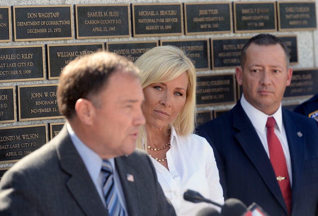 Al Hartmann | The Salt Lake Tribune
Nannette Wride, widow of slain Utah County Sheriff Sgt. Cory Wride listens as Gov. Gary Herberts speaks at police memorial outside the Utah Capitol before signing HB 288, which provides death benefits for Utah peace
officers and firefighters killed in the line of duty. Rep. Paul Ray, the bills sponsor at right.