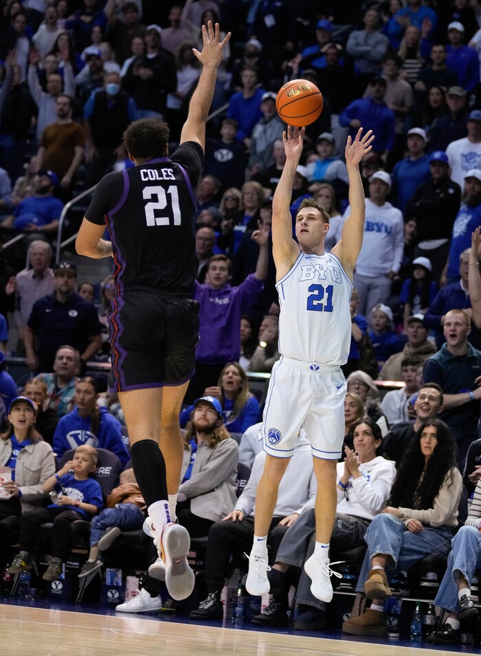 (Francisco Kjolseth | The Salt Lake Tribune) Brigham Young Cougars guard Trevin Knell (21) sinks a three point shot over TCU Horned Frogs forward JaKobe Coles (21) during an NCAA college basketball game against TCU Saturday, March 2, 2024, in Provo, Utah.