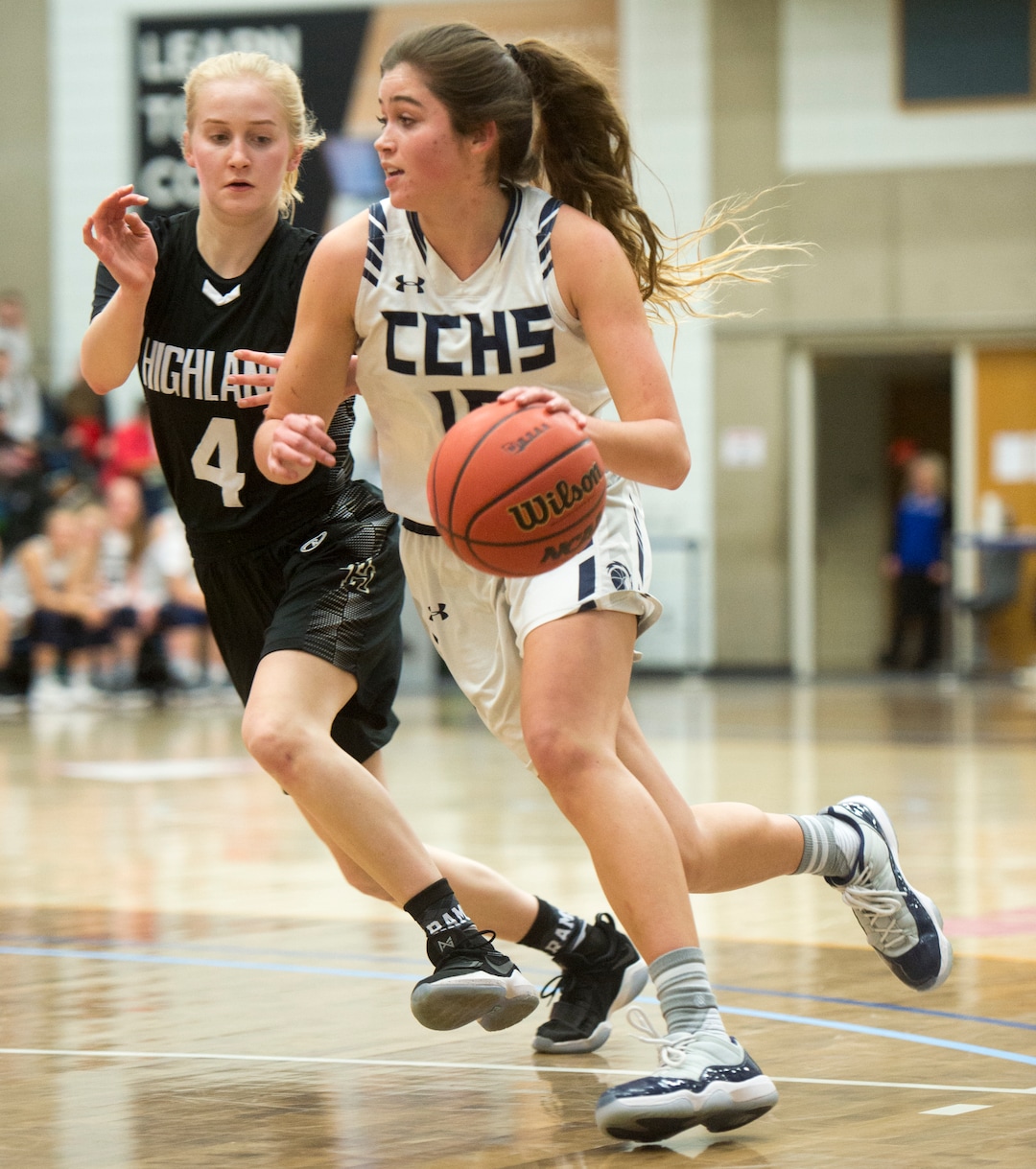 (Rick Egan  |  The Salt Lake Tribune)   Corner Canyon Chargers Kemery Martin (15) gets past Highand High Rams Olivia Beckstead (4), in Class 5A women's basketball playoff game between Corner Canyon and Highland, Monday, Feb. 19, 2018.