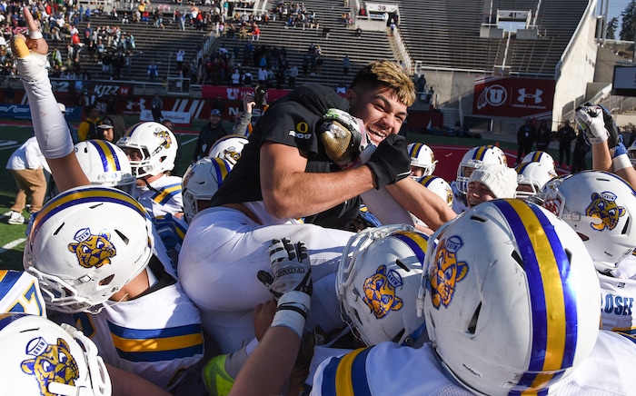 (Francisco Kjolseth  |  The Salt Lake Tribune)  Orem's Puka Nacua celebrates as he leaps over his teammates after clutching the state record for touchdowns with 26 against Dixie in the 4A high school championship game at Rice Eccles Stadium in Salt Lake City, Friday, Nov. 16, 2018.