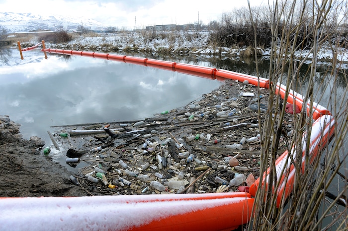 (Al Hartmann | The Salt Lake Tribune)
Booms along the Jordan RIver at about 1700 West and Center Street in North Salt Lake are collecting trash, especially plastic that makes its way down the Jordan River and into the Great Salt Lake where it kills birds. The Natiure Conservency worked with Salt Lake County and private landowners to install the trash-catching booms. They can then be manually cleaned before it reaches the lake.