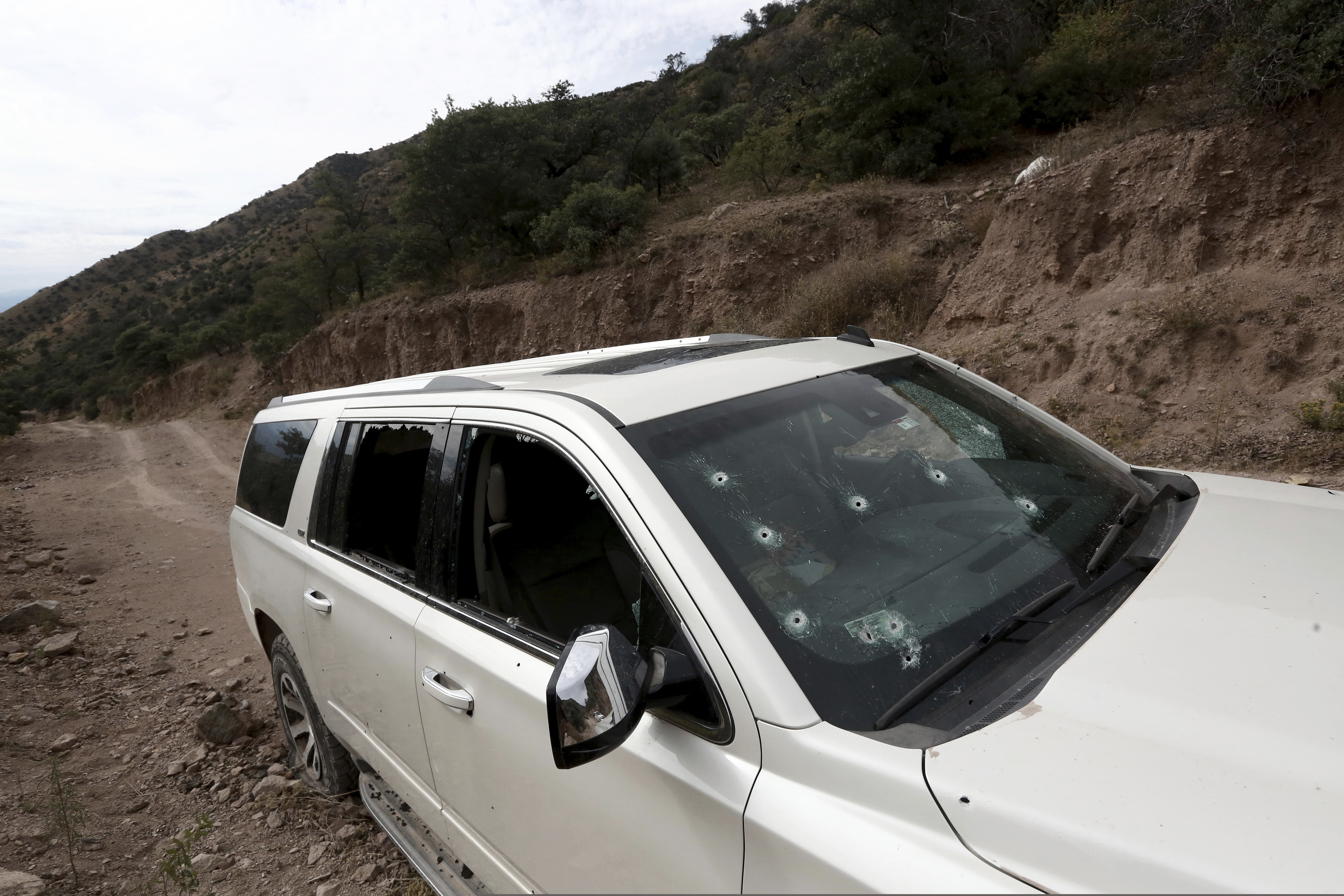 (Christian Chavez | AP) A bullet-riddled vehicle that members of LeBaron family were traveling in sits parked on a dirt road near Bavispe, at the Sonora-Chihuahua border, Mexico, Wednesday, Nov 6, 2019. Three women and six of their children, related to the extended LeBaron family, were gunned down in an attack while traveling along Mexico's Chihuahua and Sonora state border on Monday.