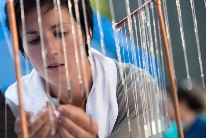 (Leah Hogsten | The Salt Lake Tribune) Dana Barraco picks out necklaces for herself and two friends from The Bearded Jeweler at the 9th Annual Craft Lake City DIY Festival, Friday, August 11, 2017 with over 250 local artisans, DIY engineers, vintage vendors, and craft food creators. The festival also features live music and dance performances, local food trucks and runs through Sunday, August 13th at the Gallivan Center.