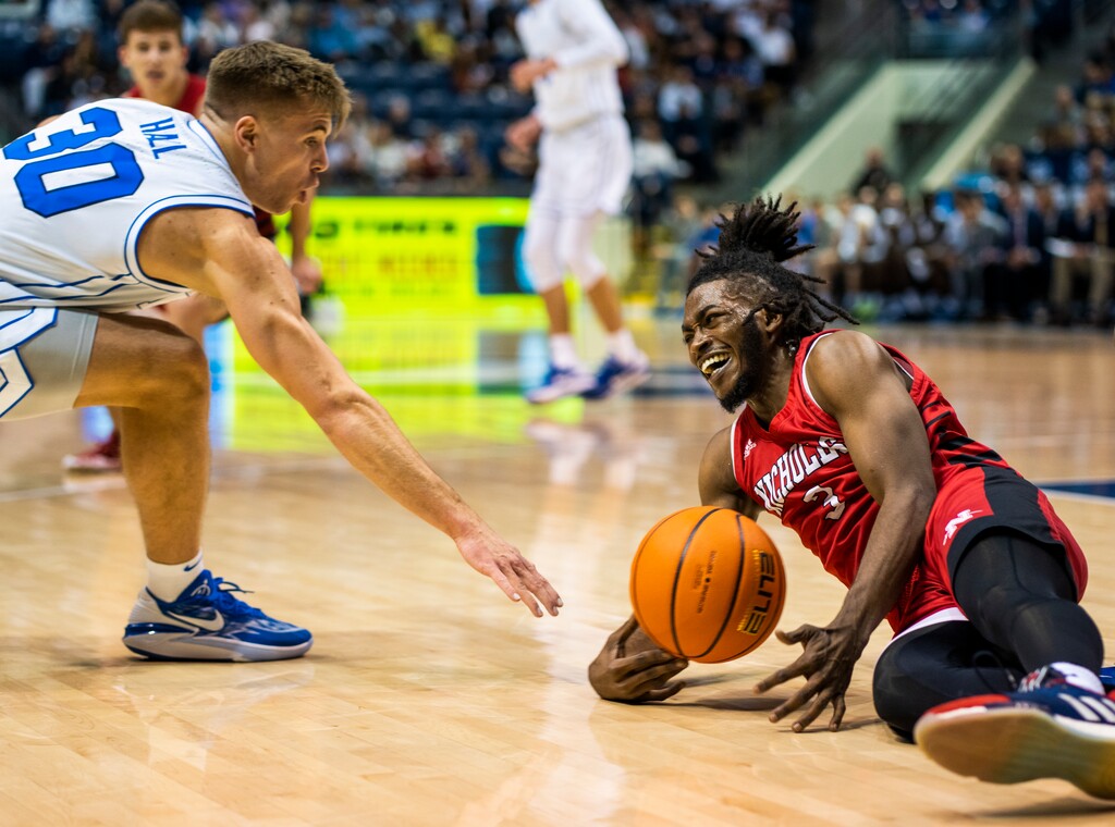(Rick Egan | The Salt Lake Tribune) Brigham Young Cougars guard Dallin Hall (30) and Nicholls State Colonels guard Micah Thomas (3), go for a loose ball, in basketball action between the Nicholls State Colonels and the Brigham Young Cougars, at the Marriott Center in Provo, on Saturday, Nov. 19, 2022.