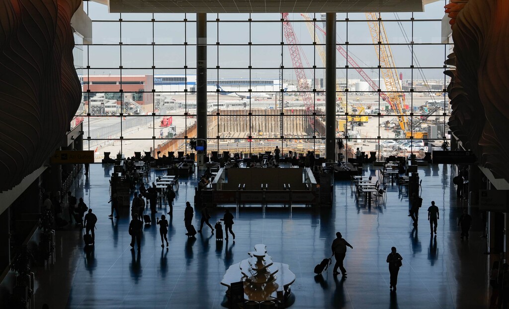 (Francisco Kjolseth | The Salt Lake Tribune) Travelers navigate the new Salt Lake City International Airport on Wednesday, Sept. 15, 2021, on the one-year anniversary of the The New SLC - Phase 1 airport, as the new central tunnel begins to take shape beyond the windows. 